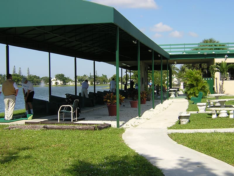 Golfers practicing under the canopy at Aqua Golf